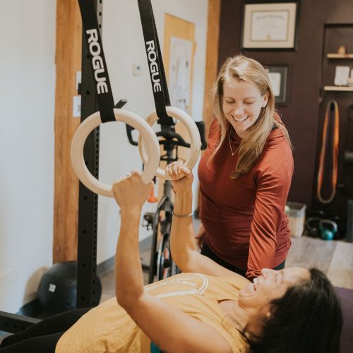 therapist working with a patient holding onto therapy rings