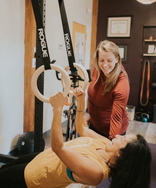 therapist working with a patient holding onto therapy rings